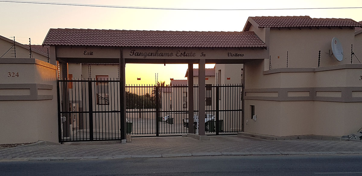 Tangenhamo Estate branded entrance gate at golden hour